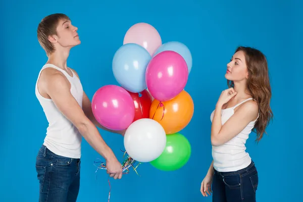 Young boy presenting baloons to a girl — Stock Photo, Image