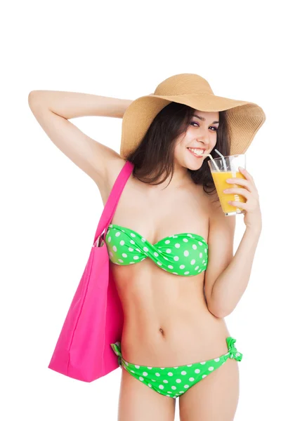 Brunette girl in green swimsuit and hat, holding glass of orange — Stock Photo, Image