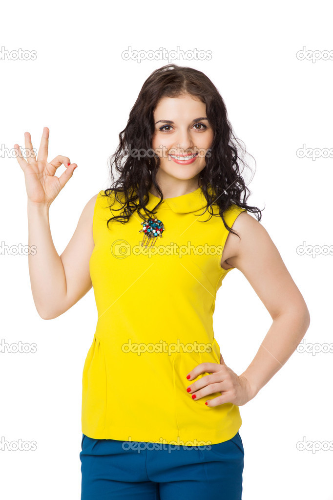 brunette happy girl with curly hair wearing yellow blouse showin