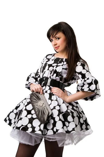 Beautiful brunette in black and white dress holding little purse — Stock Photo, Image