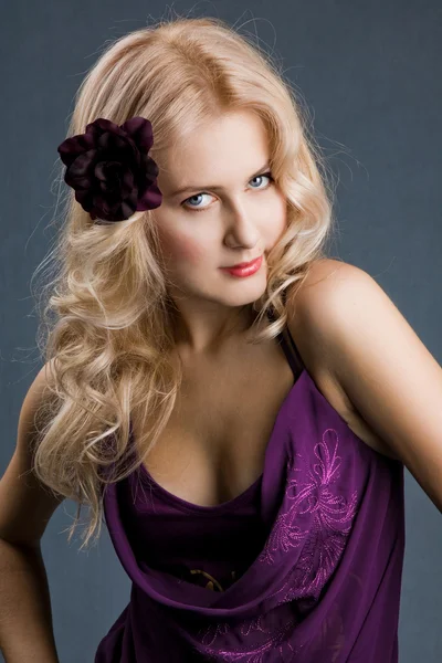 Beautiful blonde girl in purple dress — Stock Photo, Image