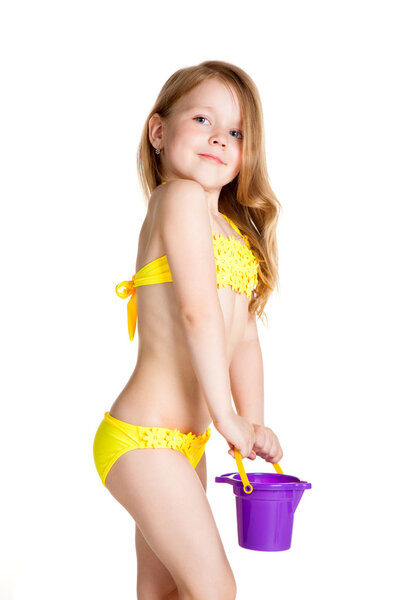 little blonde happy girl in yellow swimsuit holding toy purple b