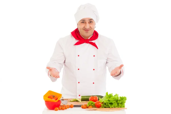 Happy chef cooking with fresh vegetables wearing red and white — Stock Photo, Image
