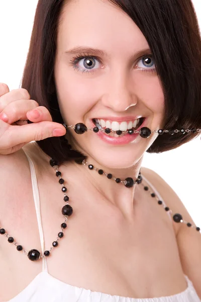 Beautiful girl holding beads in her mouth — Stock Photo, Image