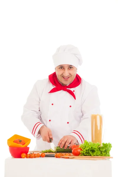 Счастливый шеф-повар готовит из свежих овощей в красном и белом — стоковое фото
