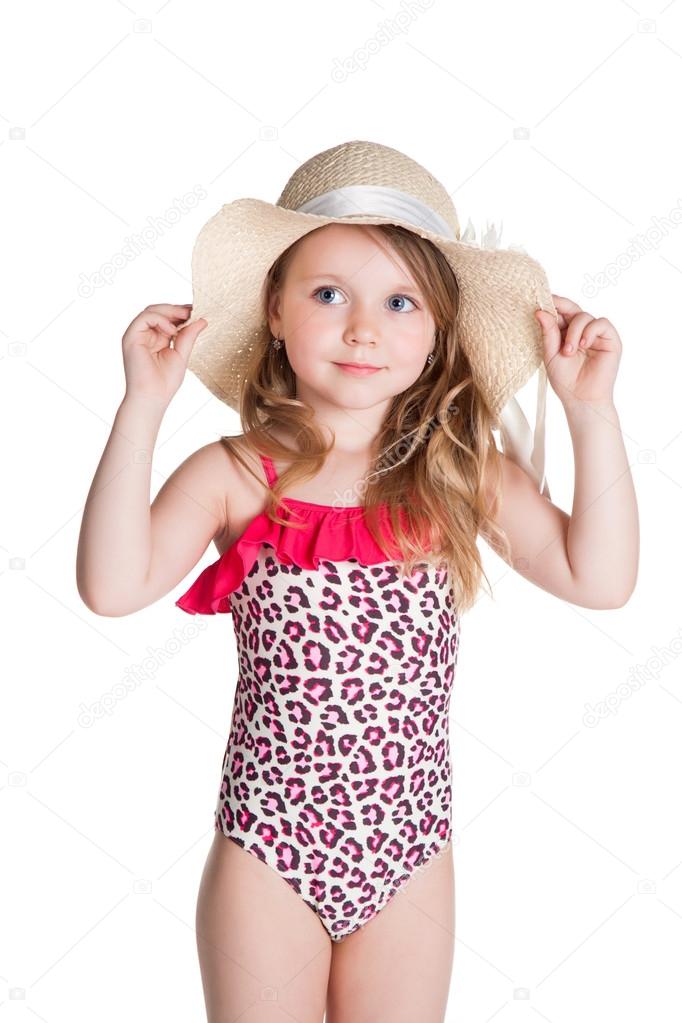 little blonde happy girl in pink swimsuit holding hat