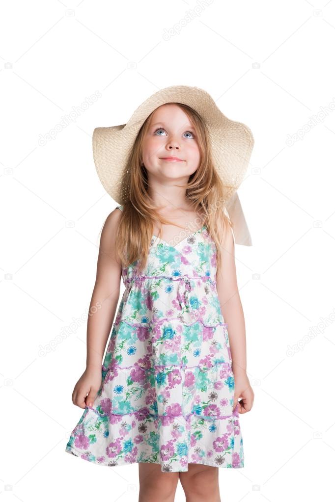 little blonde girl wearing big white hat and dress looking up