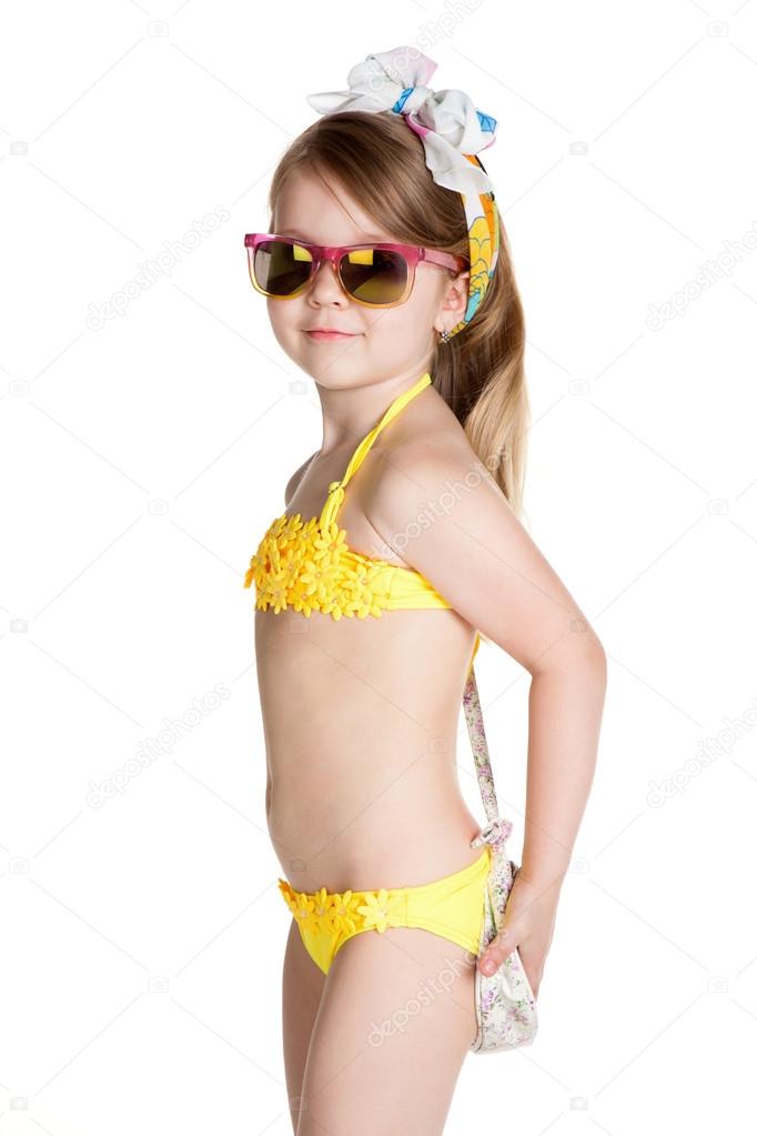 little blonde girl wearing swimsuit, sun glasses and bag