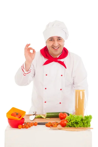 Happy chef cooking with fresh vegetables wearing red and white — Stock Photo, Image