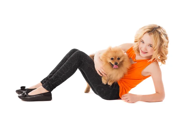 Little smiling girl holding her dog — Stock Photo, Image