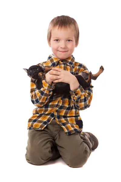 Sorrindo menino segurando seu filhote de cachorro — Fotografia de Stock