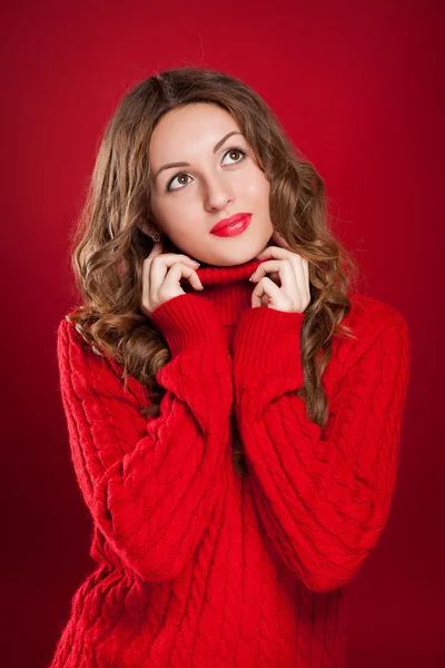 Beautiful brunette girl wearing red sweater — Stock Photo, Image