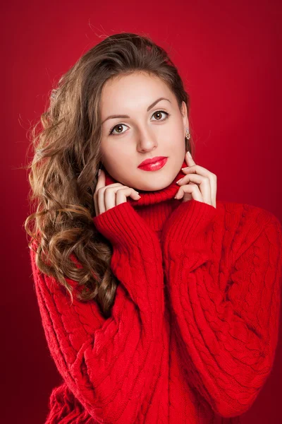 Beautiful brunette girl wearing red sweater — Stock Photo, Image