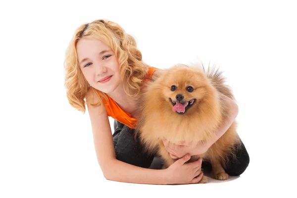 Kleines blondes lächelndes Mädchen hält ihren Hund — Stockfoto