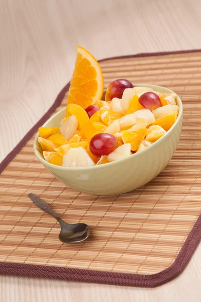 Bowl with fruit salad with piece of orange — Stock Photo, Image