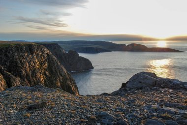 Scenic view of sunset over Knivsjelloden Cape and ocean from Nordkapp cliff, Mageroya island, Norway