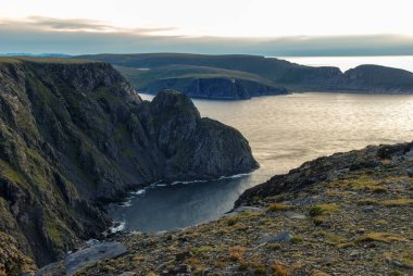 View of Nordkapp cliff with a globe statue and Nordkapphallen tourist hall, Mageroya island, Nordkapp