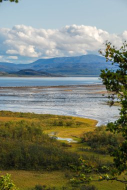 View of Nordkapp cliff with a globe statue and Nordkapphallen tourist hall, Mageroya island, Nordkapp