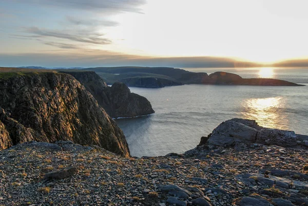Scenic view of sunset over Knivsjelloden Cape and ocean from Nordkapp cliff, Mageroya island, Norway