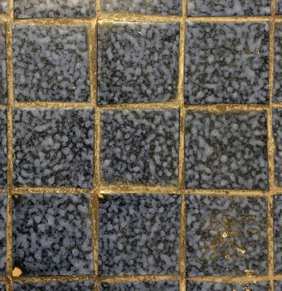 detail of an old ceramic coating of a bathroom