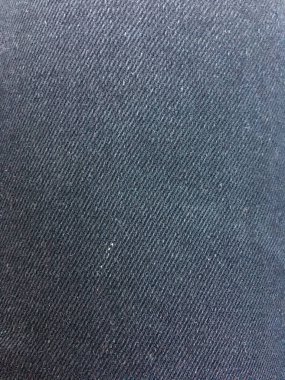 Siyah bir kot pantolonun kumaşının soyut dokusu