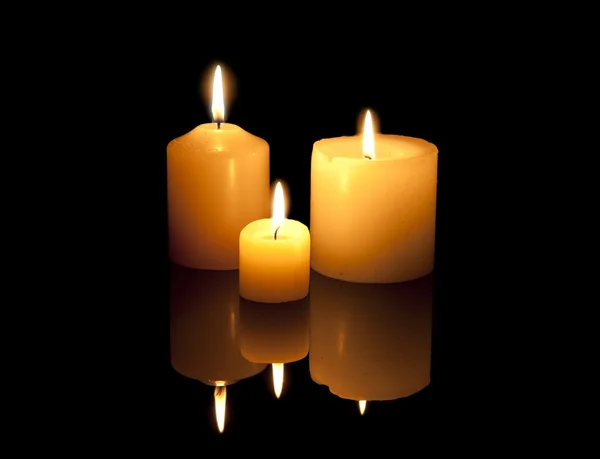 Three burning candles with reflexion Royalty Free Stock Images