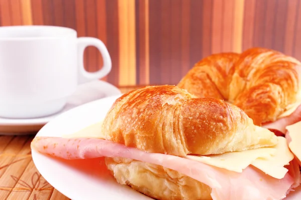 Coffee with croissants with ham and cheese — Stock Photo, Image