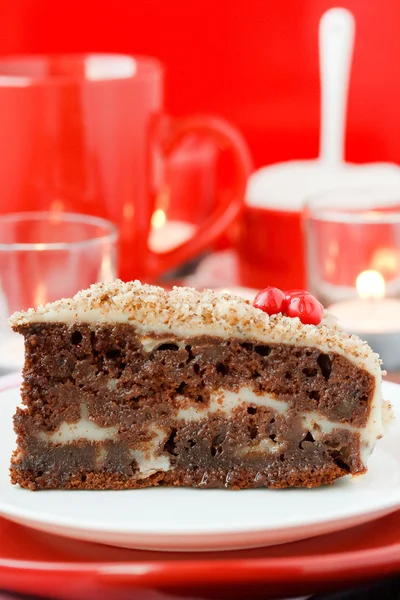 Cocolate cake with nuts on a red background. New Year's cake. — Stock Photo, Image