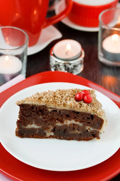 Cocolate cake with nuts on a red background. New Year's cake. — Stock Photo, Image