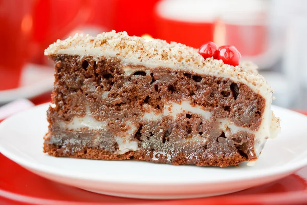 Cocolate cake with nuts. On a red background. — Stock Photo, Image