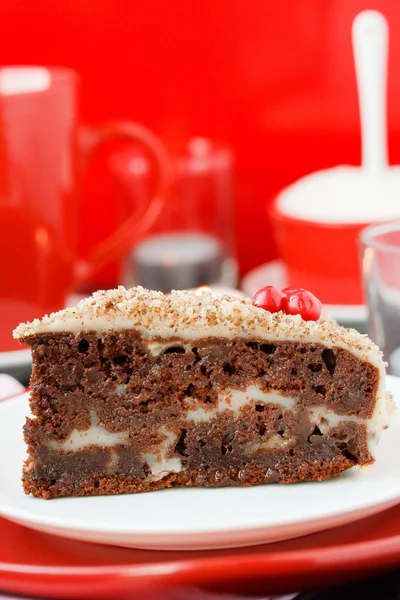 Cocolate cake with nuts on a red background. New Year's cake.