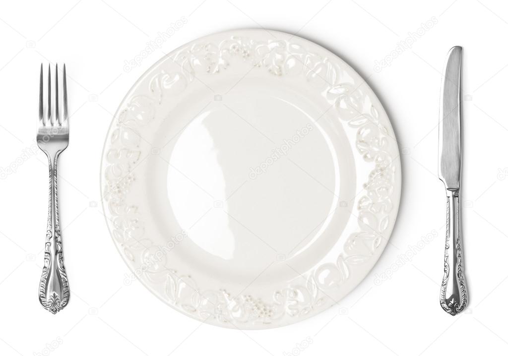 Vintage plate, knife and fork on white background