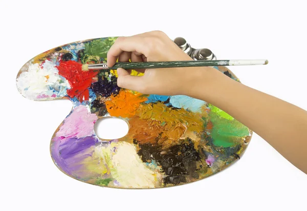 Artists hands holding a paint brush and palette — Stock Photo, Image