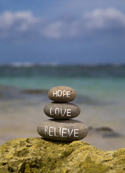 Believe hope love written on stones — Stock Photo, Image