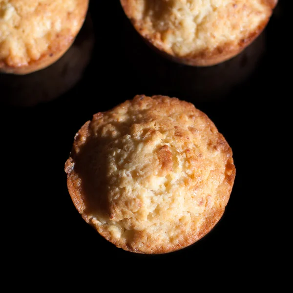 Tres cupcakes sobre un fondo negro — Foto de Stock