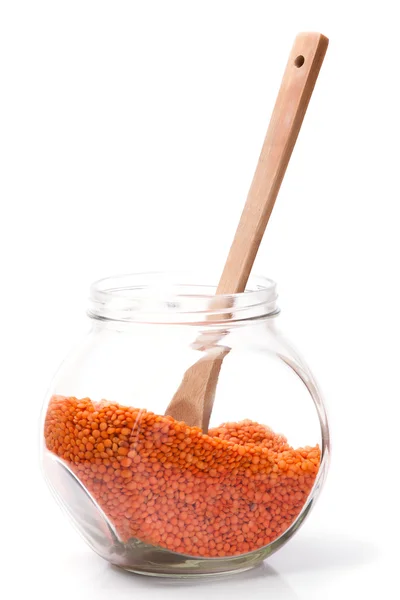Lentilhas vermelhas em um frasco de vidro — Fotografia de Stock