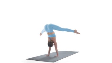 Young athletic attractive woman practicing yoga isolated on whit