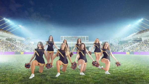 Group of cheerleaders in action on  stadium in night