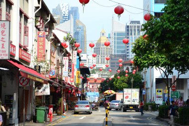 Chinatown shophouses and lanterns against modern city skyline, Singapore clipart
