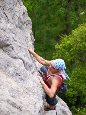 Climbing man on high rocks clipart