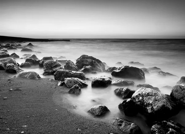 Costa y piedra durante la puesta del sol . — Foto de Stock