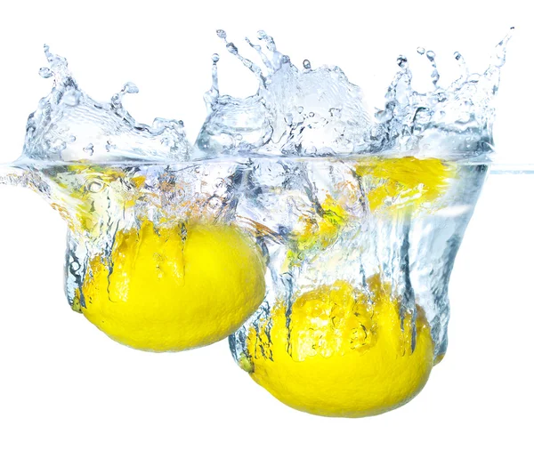 Bright yellow lemons in water — Stock Photo, Image