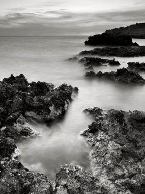 Sahil ve gün batımı sırasında taş.