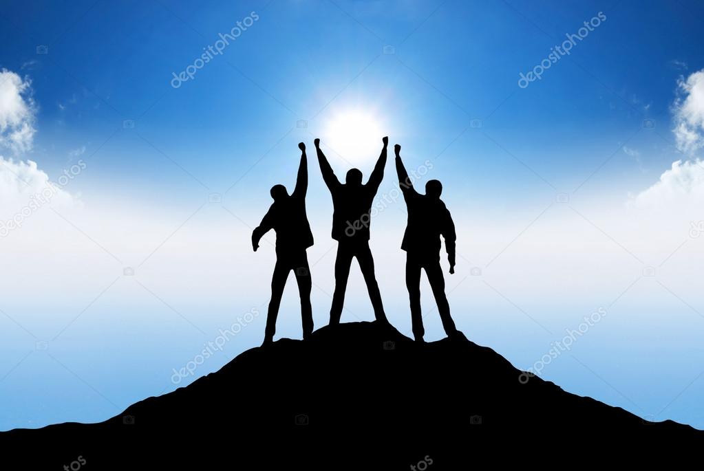Silhouette of team on the mountain top