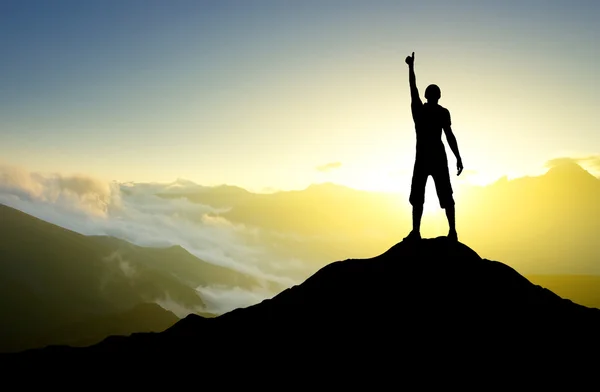 Male silhouette showing thumb up on mountain top — Stock Photo, Image