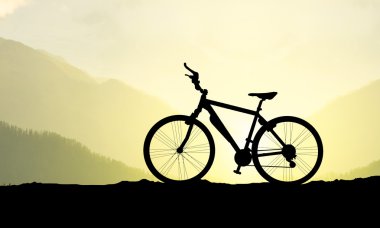 Bike silhouette on background of sundown clipart