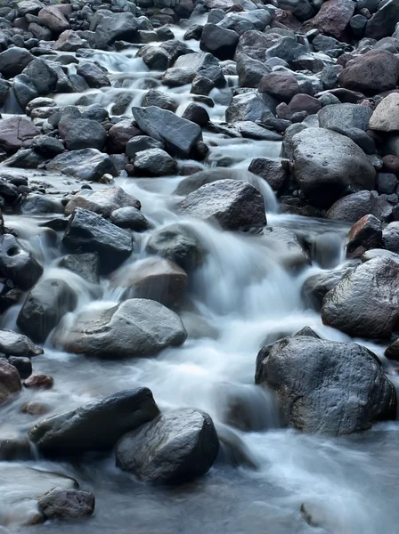 Fast river among dark stones — Stock Photo, Image