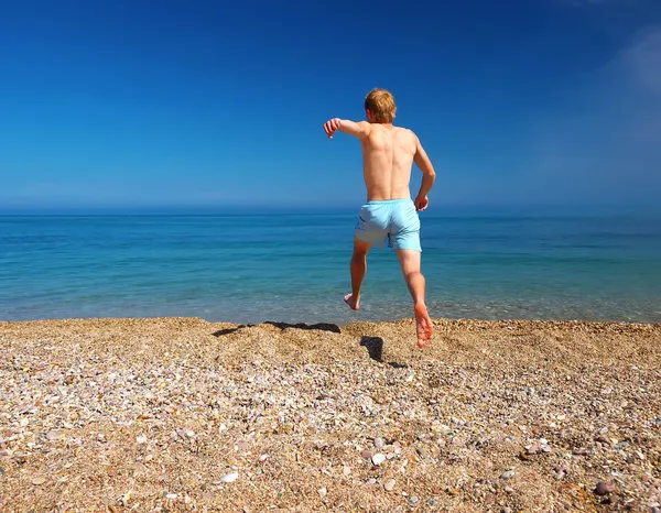 Running person on the beach Stock Picture