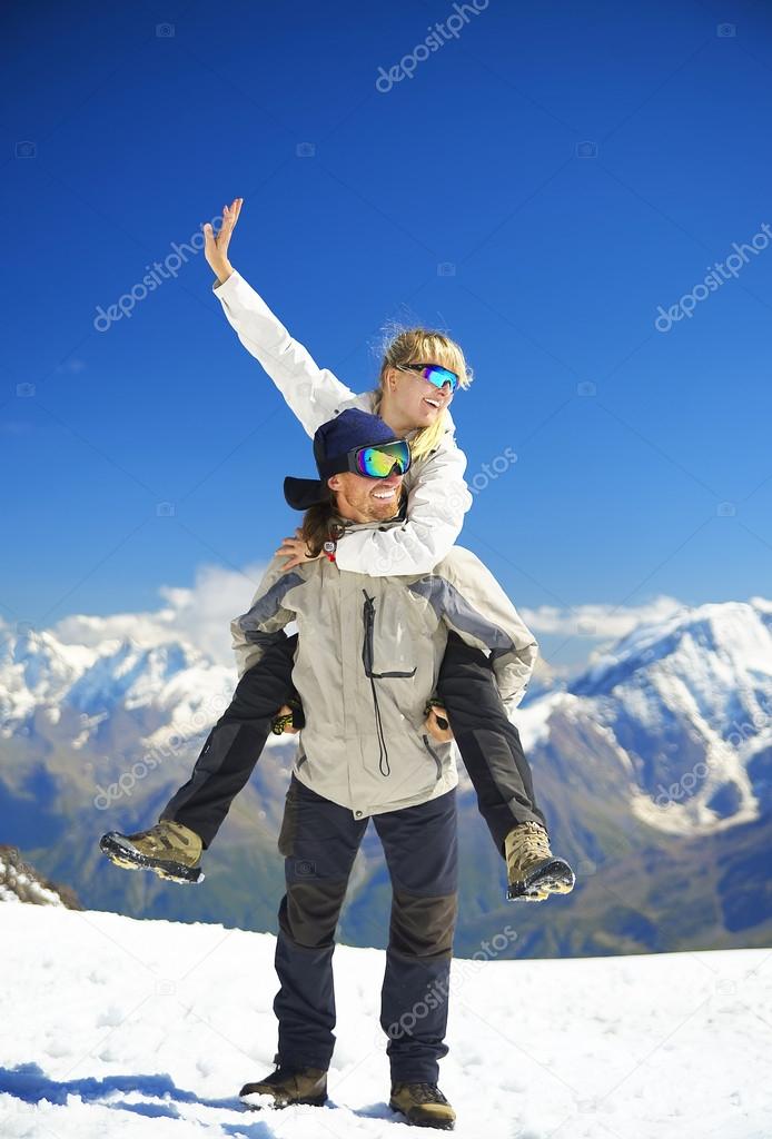 Couple on  snowy top
