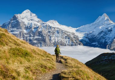 Dağlarda sırt çantalı bir turist. Yüksek dağlarda dağ yürüyüşü. Seyahat ve macera. Aktif hayat. Yaz mevsiminde manzara. Yüksek çözünürlüklü fotoğraf.